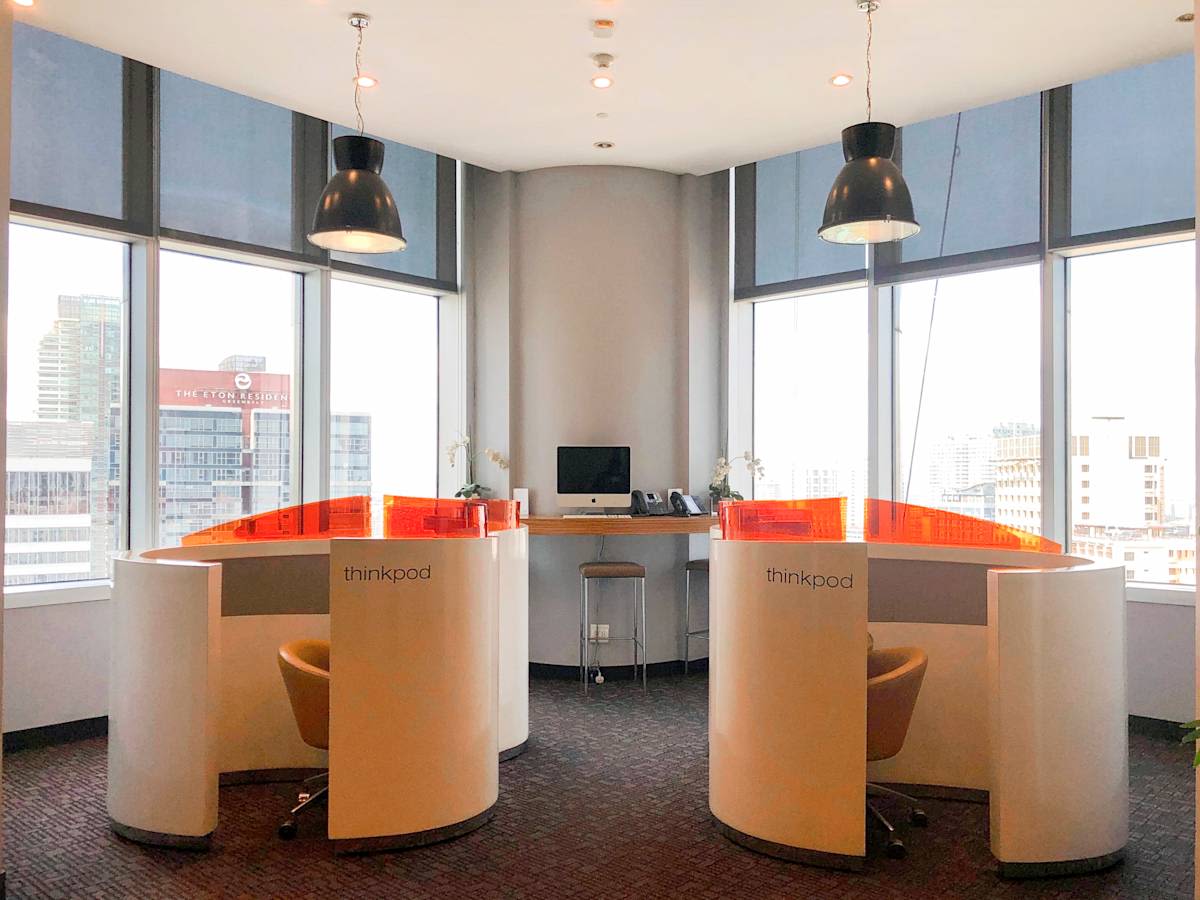 Contemporary workspace with private cubicles, ample natural light, and city views.