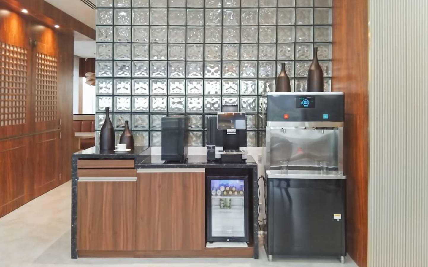 Modern kitchenette with sleek appliances and ample counter space. Ideal for a productive break area.