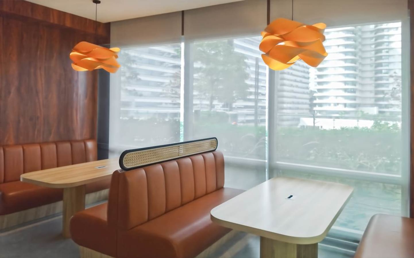 Modern office space with cozy booth seating and stylish lighting, ideal for collaboration.