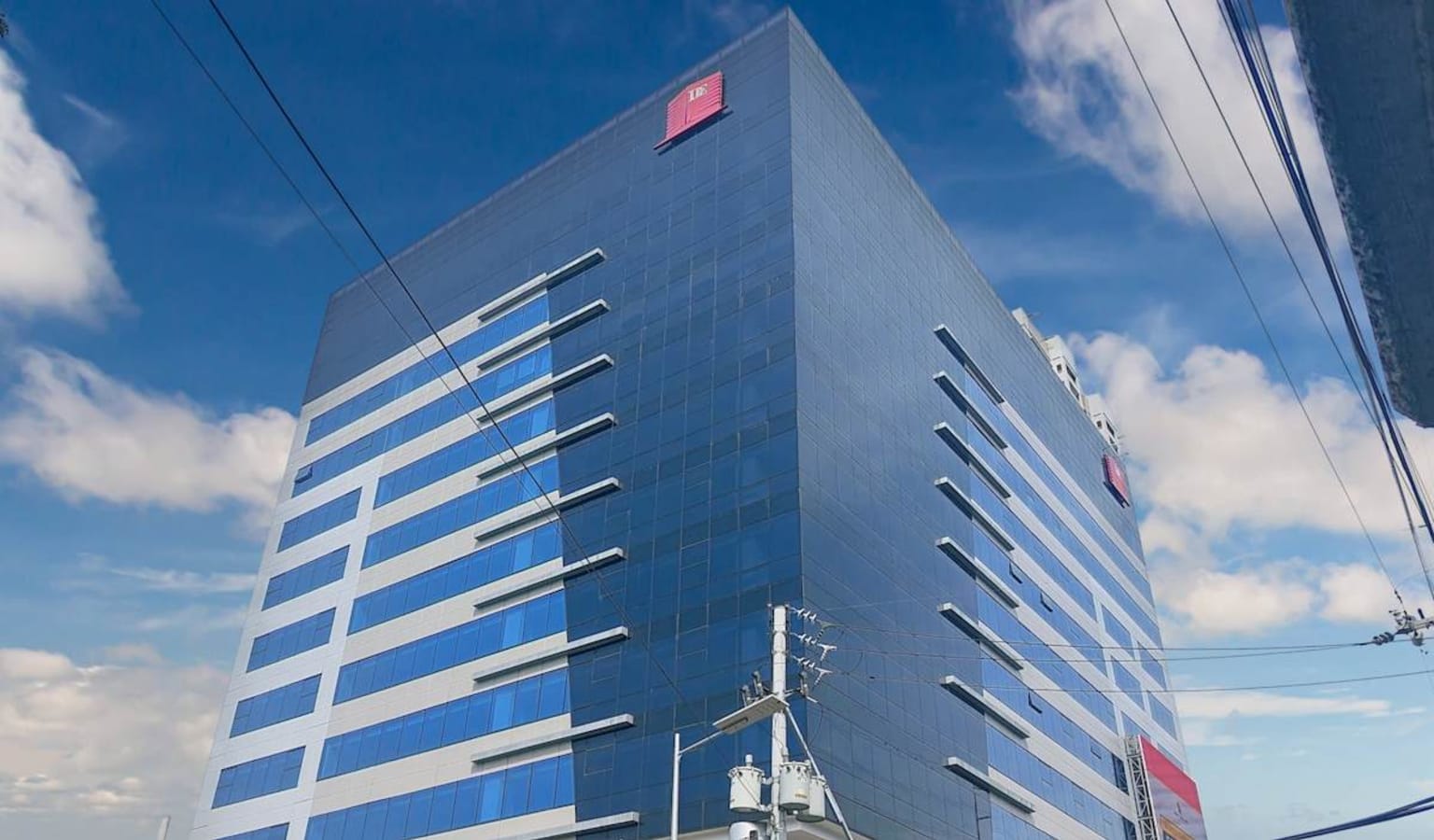 Modern high-rise office building with sleek glass facade and ample natural light. Perfect for businesses seeking a contemporary space.