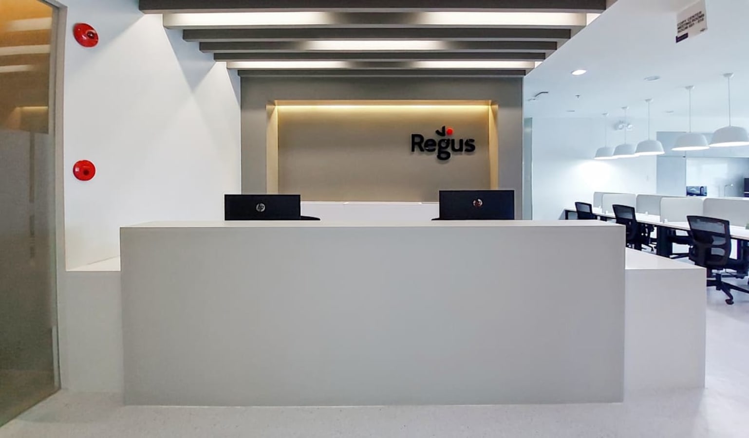 Modern reception area with sleek design and ample natural lighting. Perfect for a professional workspace.