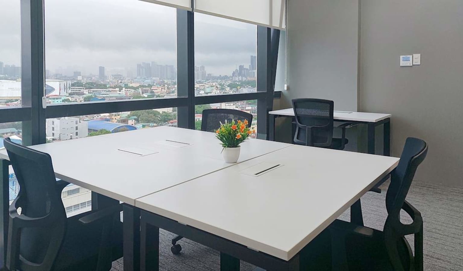 Modern workspace with city views, natural light, and ergonomic seating. Perfect for collaboration.