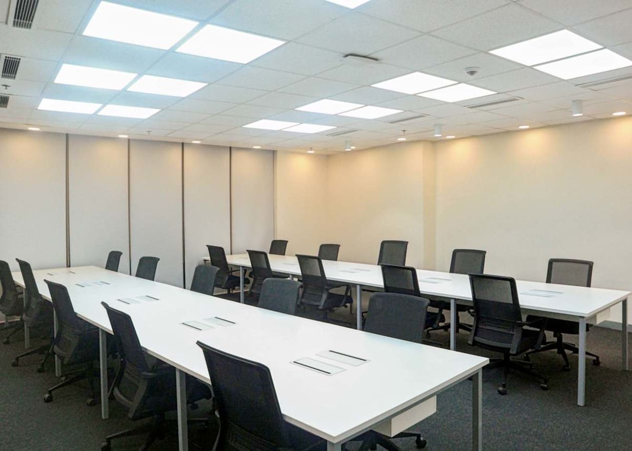 Modern workspace with sleek desks, ergonomic chairs, and bright overhead lighting.