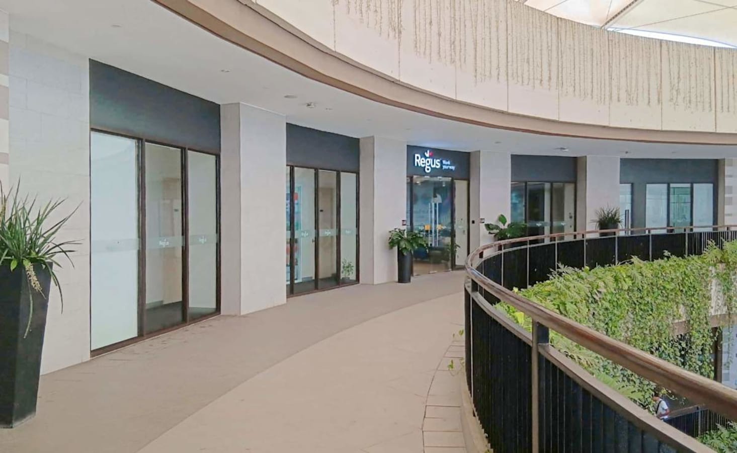 Modern office space with glass walls and natural lighting, ideal for collaboration and productivity.
