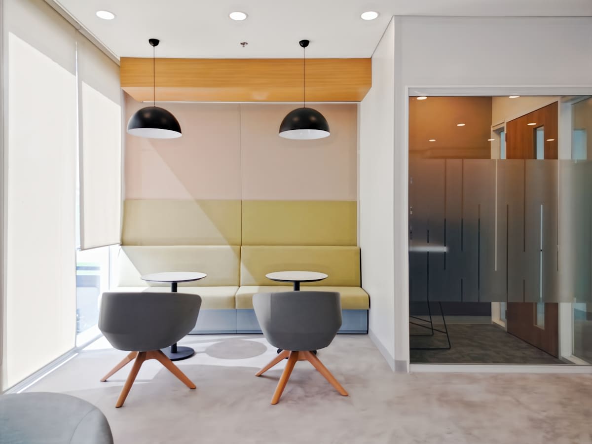 Bright coworking space with modern seating and natural light, perfect for collaboration.