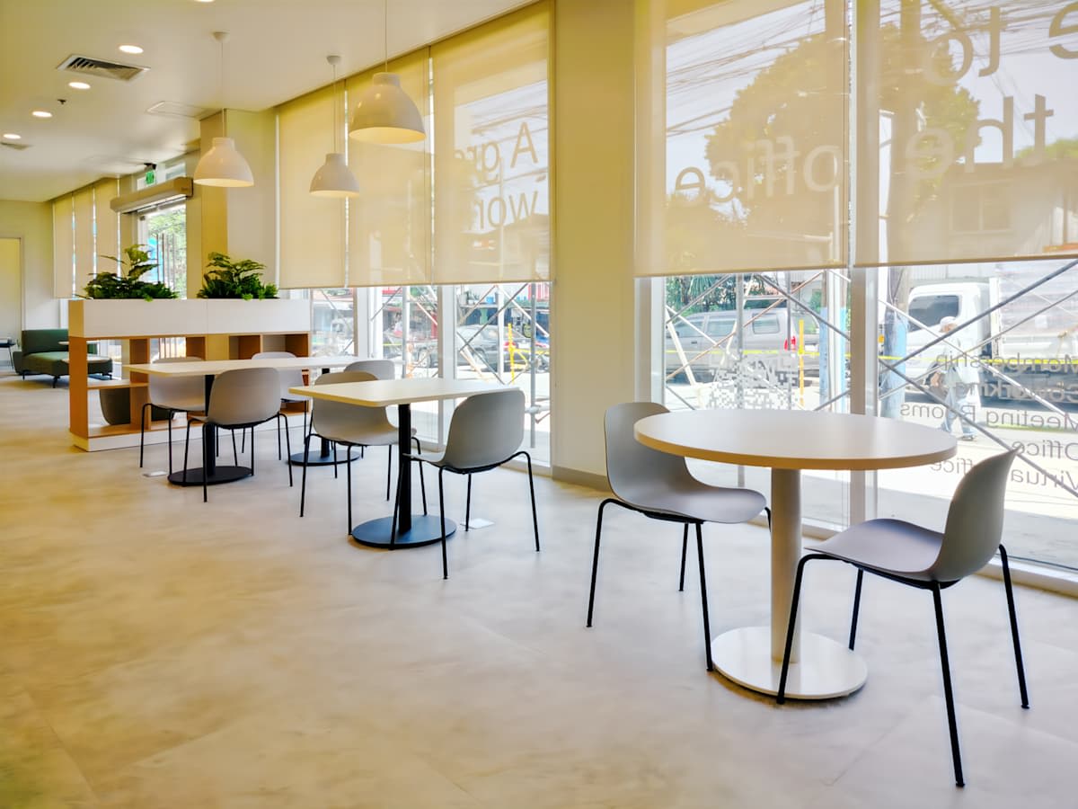 Modern coworking space with abundant natural light and flexible seating options.