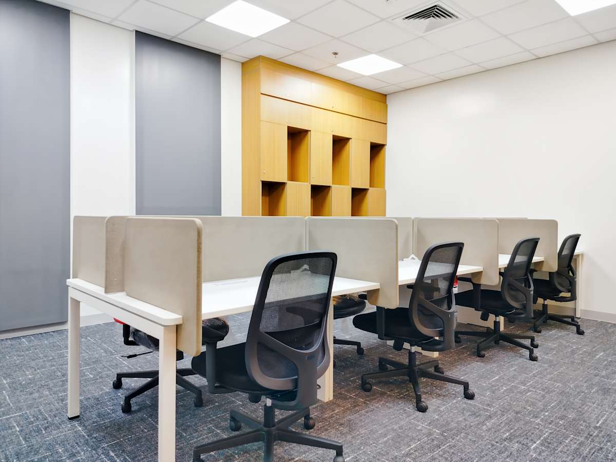 Modern workspace with sleek desks, ergonomic chairs, and ample storage. Ideal for productivity.