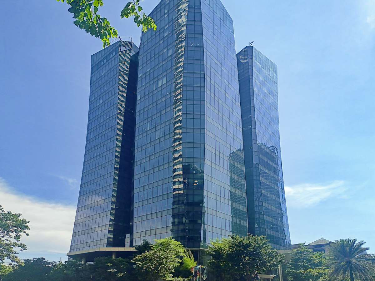 Modern coworking space in Estrella, Metro Manila, within a sleek, glass-façade skyscraper.