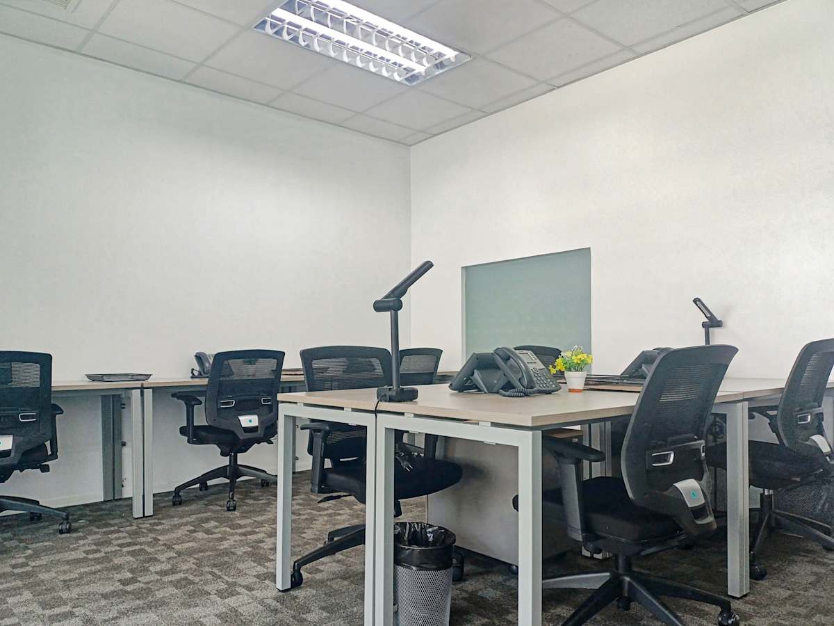 Modern coworking space in Estrella, Manila, featuring ergonomic chairs and ample desks.