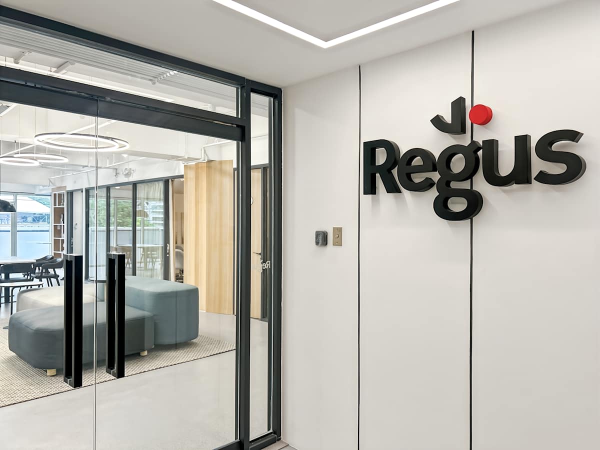 Modern coworking space with sleek glass entry and comfortable lounge seating.
