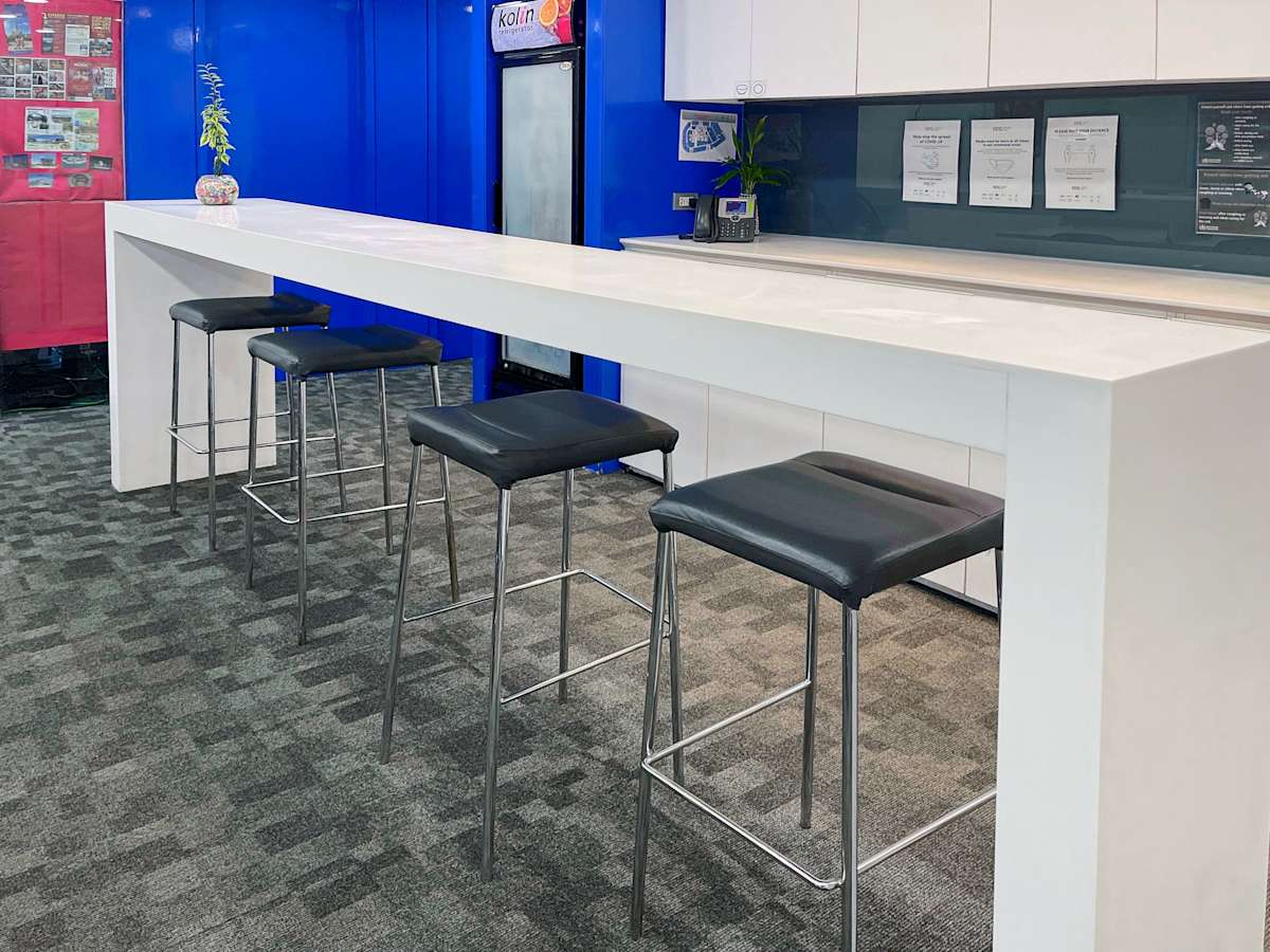 Modern coworking area with sleek bar seating and vibrant accents on United Nations Avenue.
