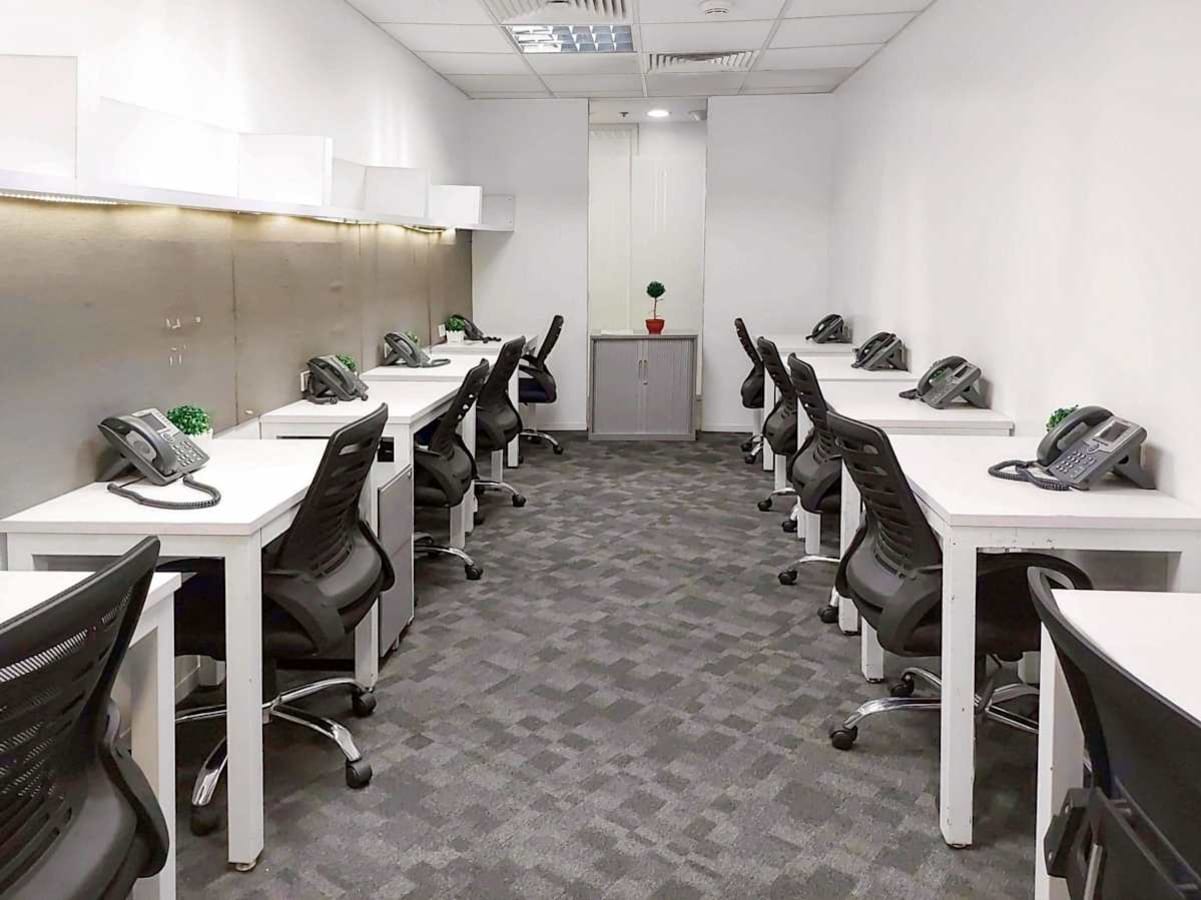 Modern coworking space with ergonomic chairs and organized workstations for productivity.