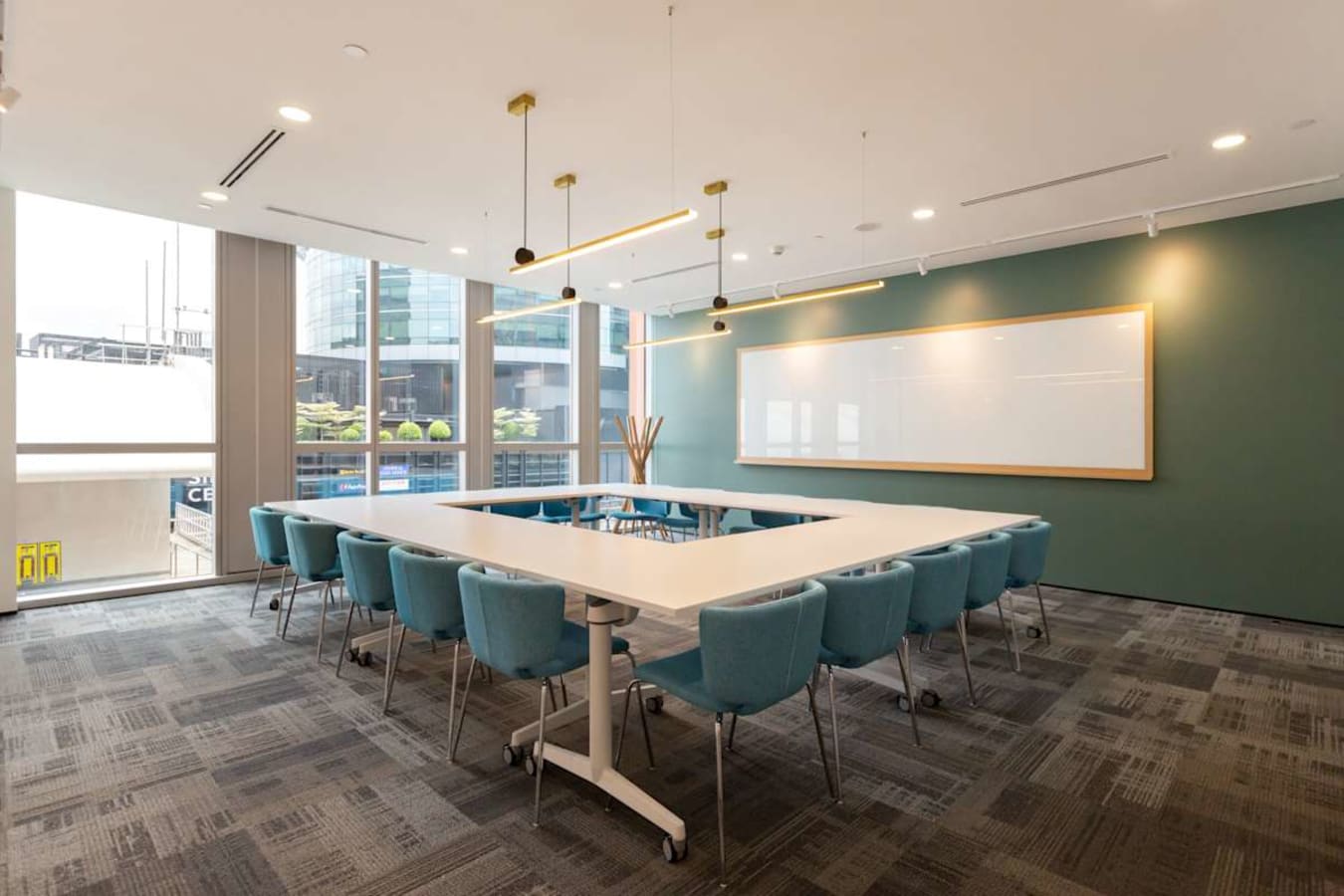 Modern meeting room with ample natural light and elegant seating, ideal for collaboration.