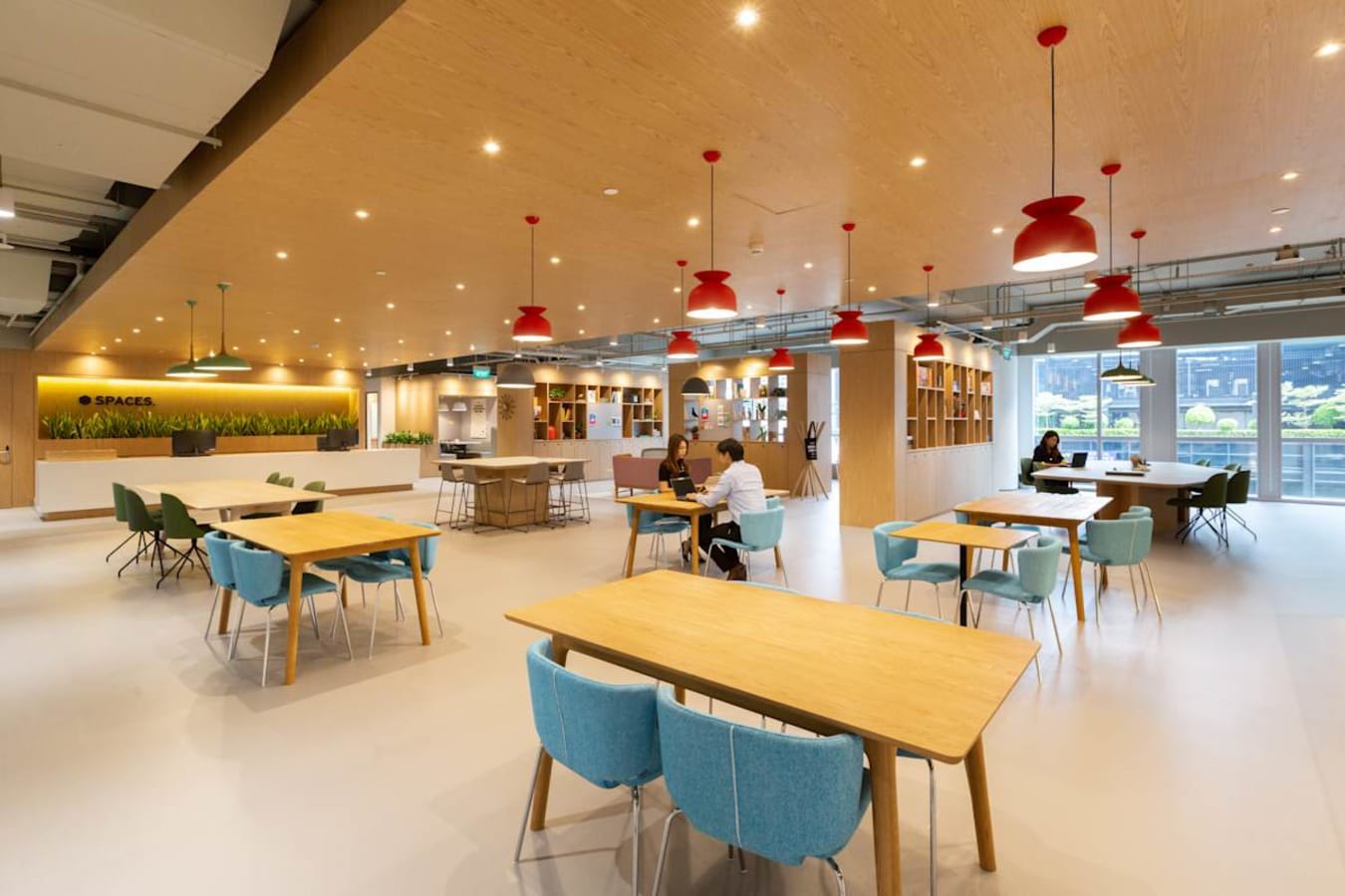 Open coworking area with modern decor, ample natural light, and versatile seating at Paya Lebar Link.