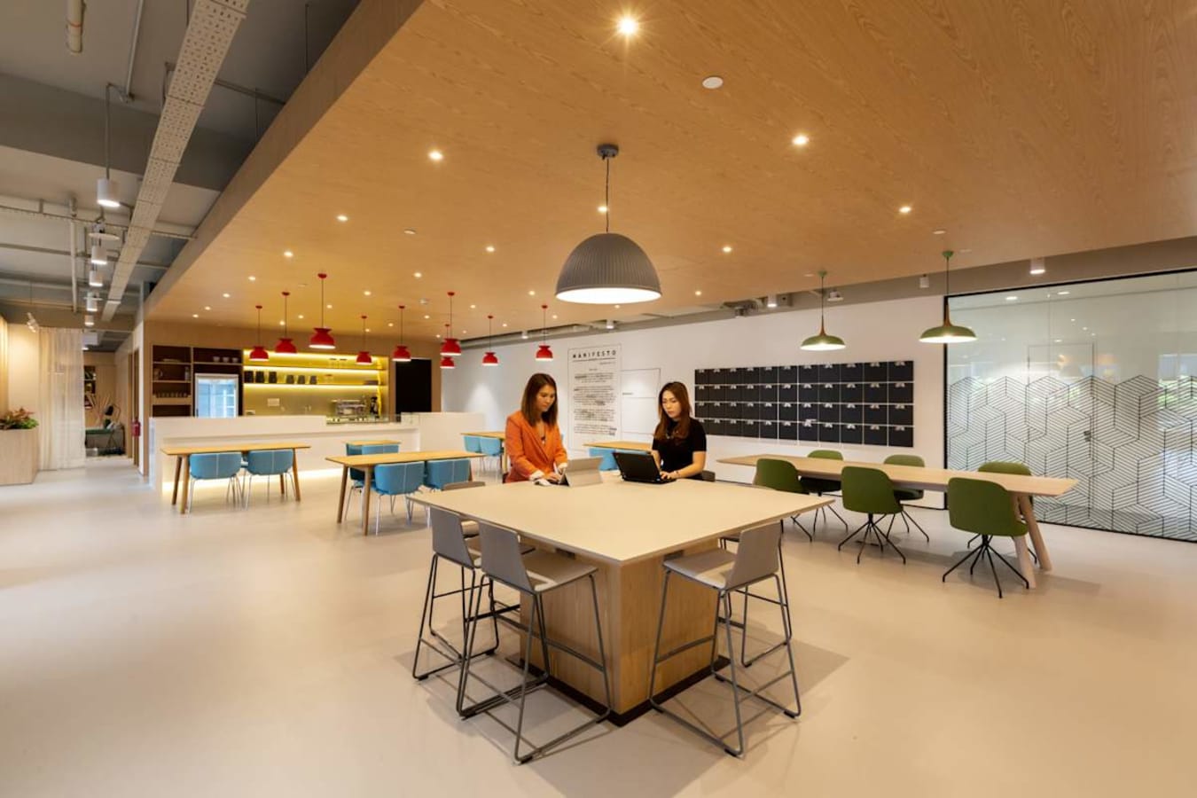 Modern coworking space in Paya Lebar Link featuring open seating, warm lighting, and contemporary design.