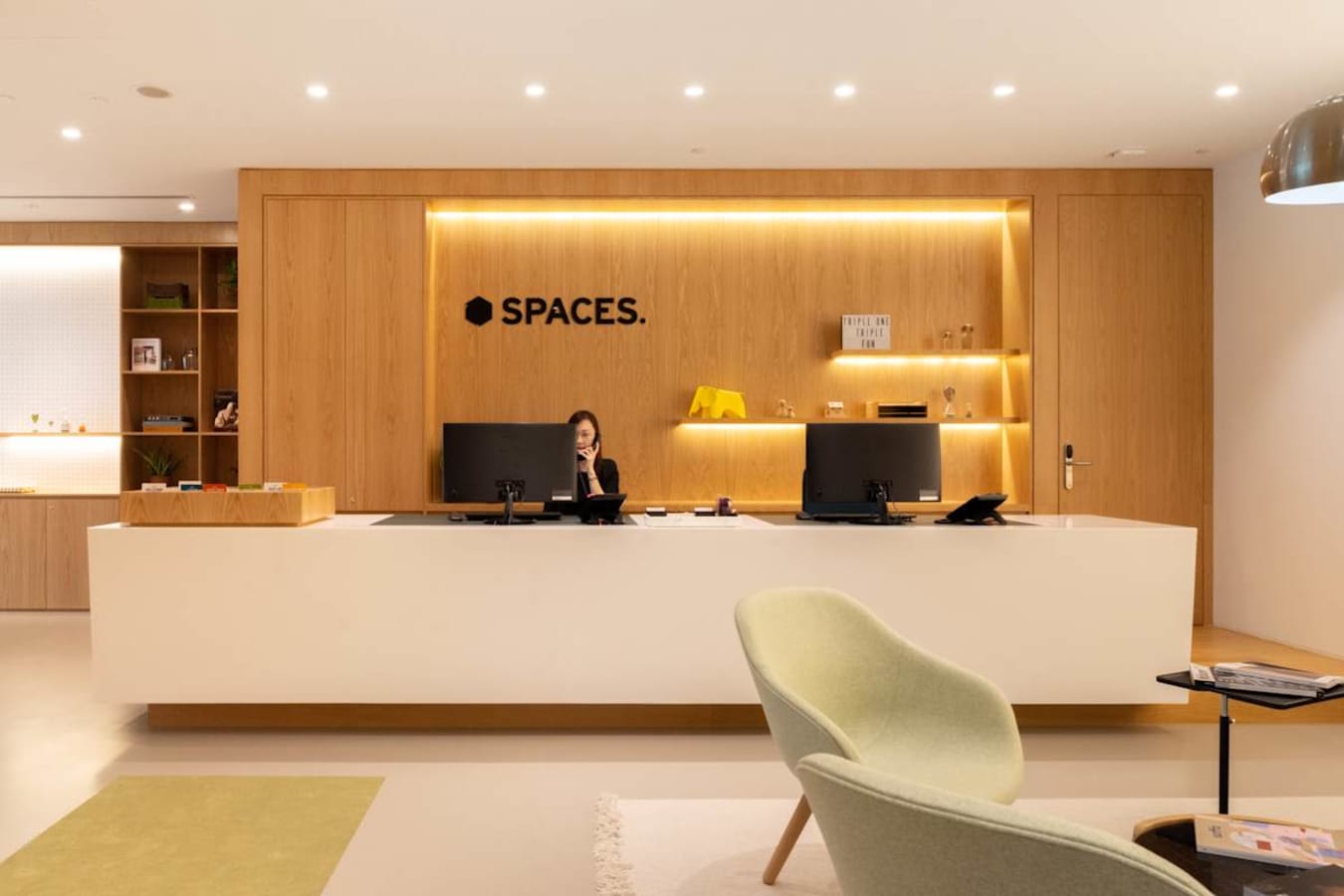 Modern coworking reception area with sleek design and ambient lighting in Somerset Road, Singapore.