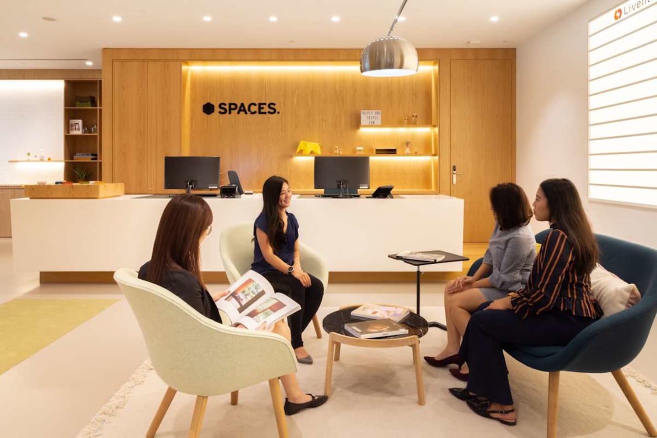 Modern coworking lounge with sleek seating and warm lighting, ideal for collaboration.