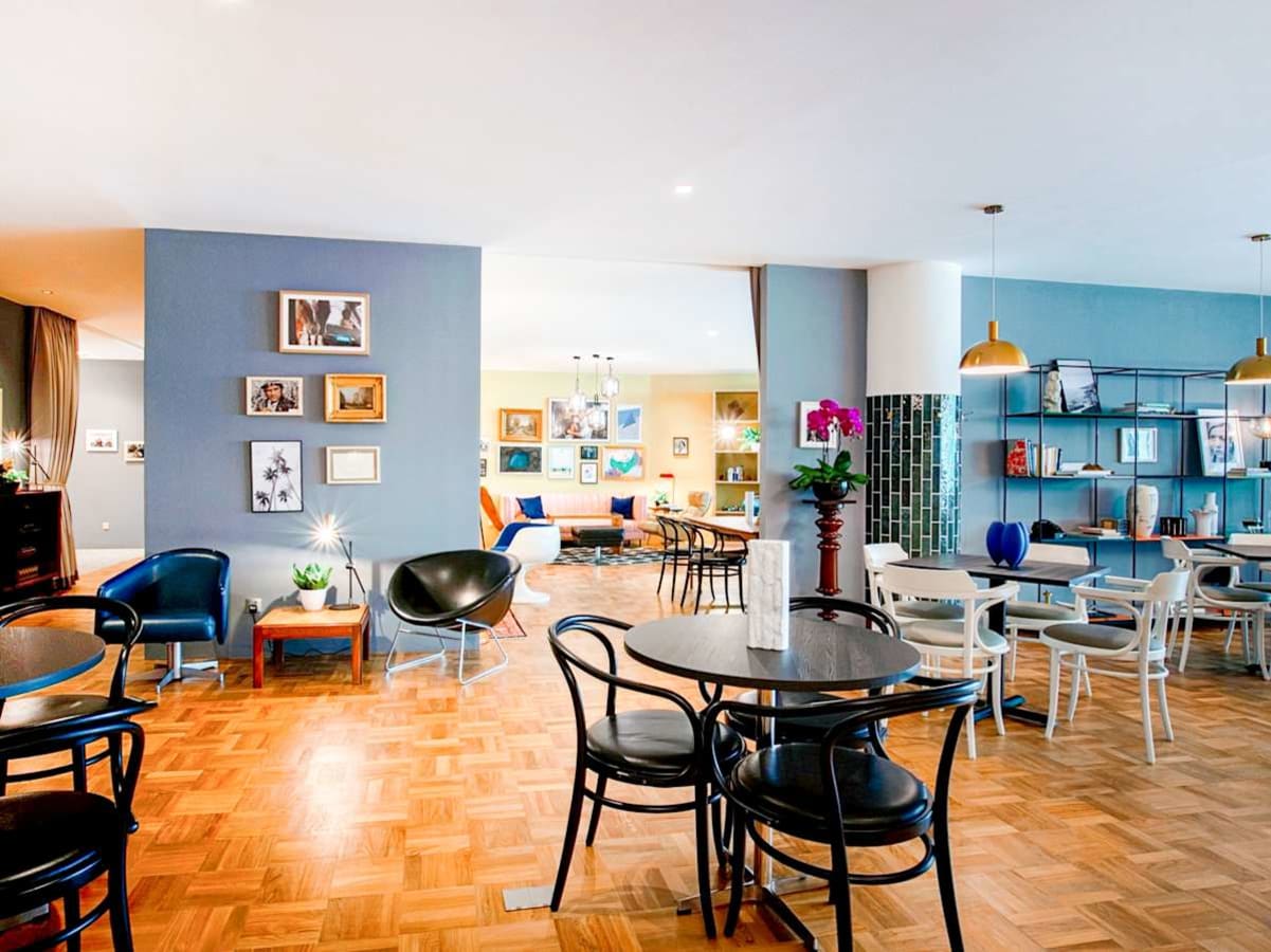 Bright, open coworking space with modern seating, vibrant decor, and ample natural light.