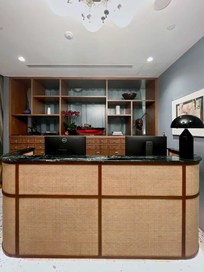 Elegant reception area with a modern desk, stylish shelving, and soft lighting. Perfect for a professional welcome.