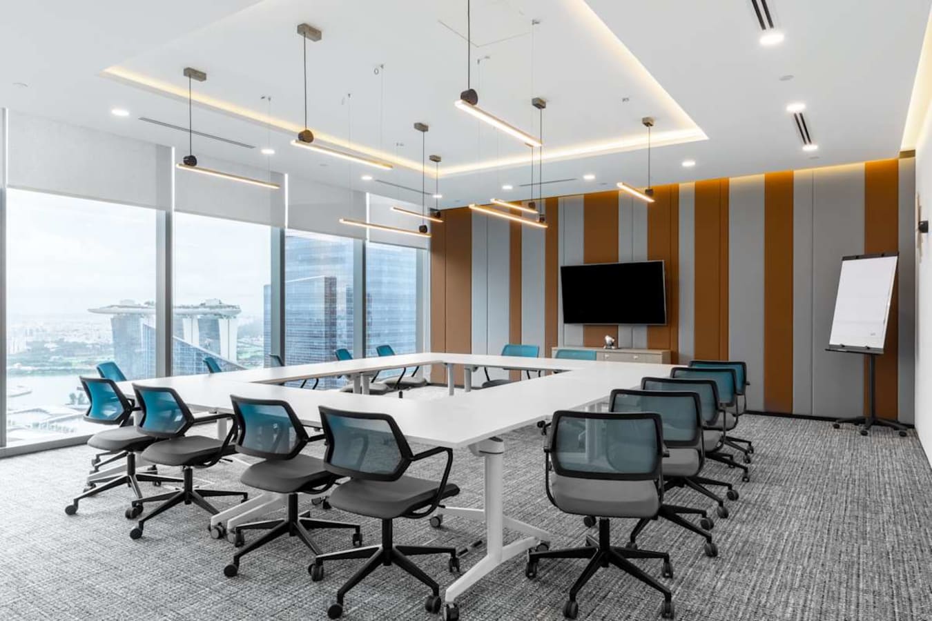 Modern coworking space with stunning Marina Bay views, sleek furniture, and ample natural light.