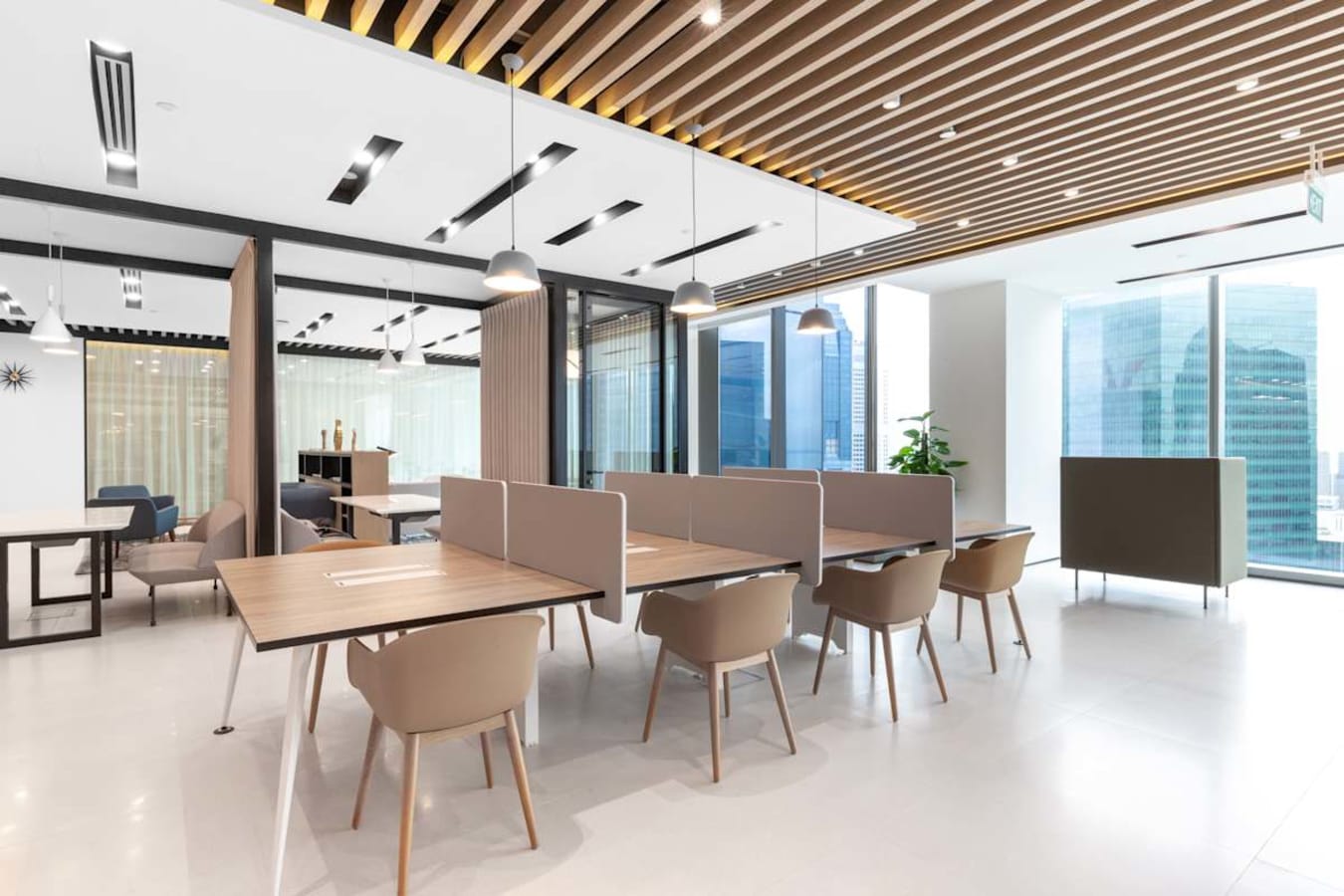 Modern coworking space with open desks, abundant natural light, and stylish decor at Marina View.