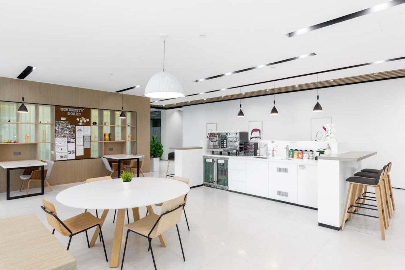 Modern coworking kitchen with sleek counters, ample seating, and natural light in Marina View.