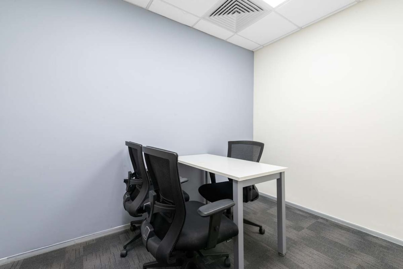 Modern coworking space with ergonomic chairs and versatile meeting table on JNTU Road.