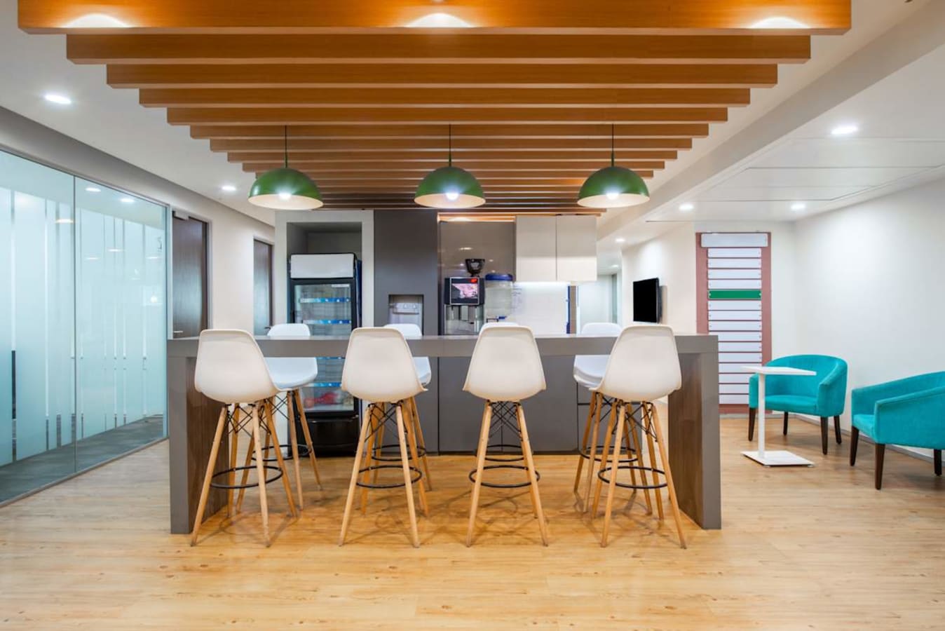 Modern coworking space with sleek seating, ample lighting, and a communal bar area on JNTU Road.