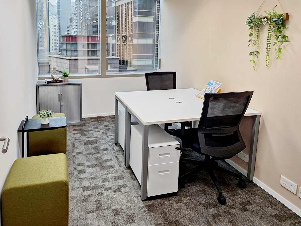 Modern coworking space with natural light, ergonomic chairs, and city views in Queen's Road Central.