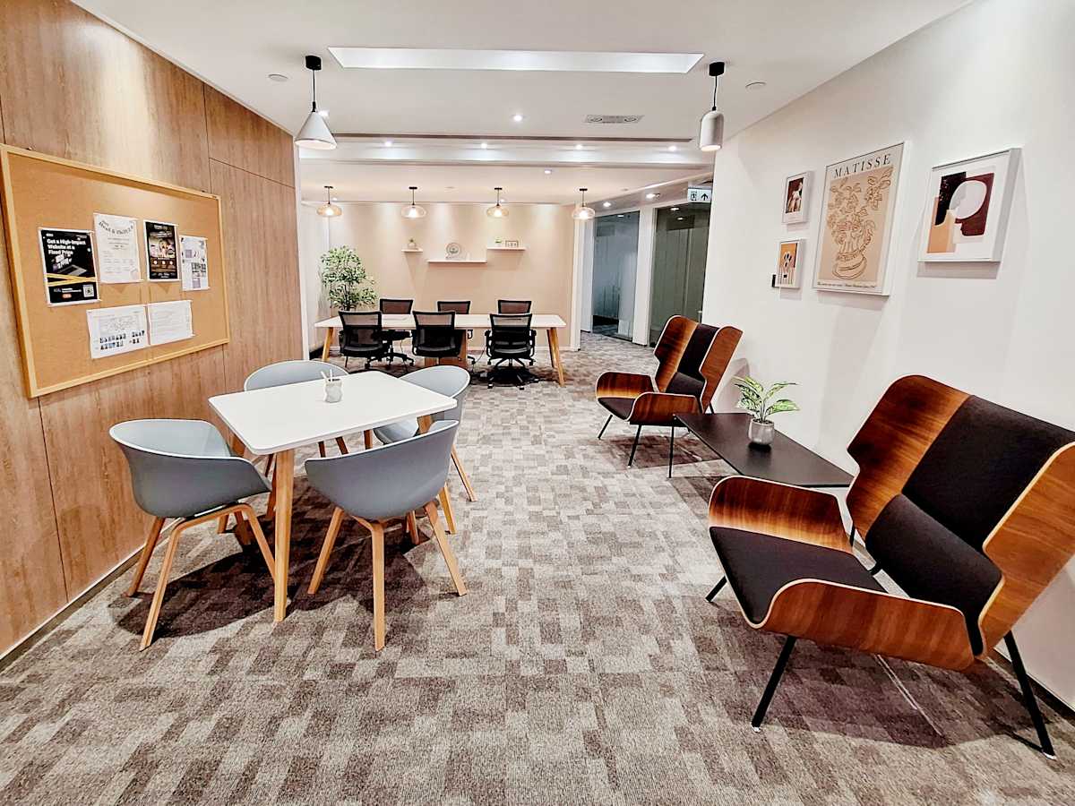 Modern coworking lounge with stylish seating, meeting area, and welcoming ambiance.