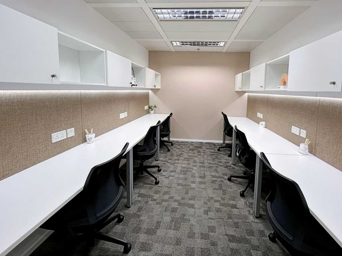Modern coworking space with sleek desks, ergonomic chairs, and ample storage in Queen's Road Central.