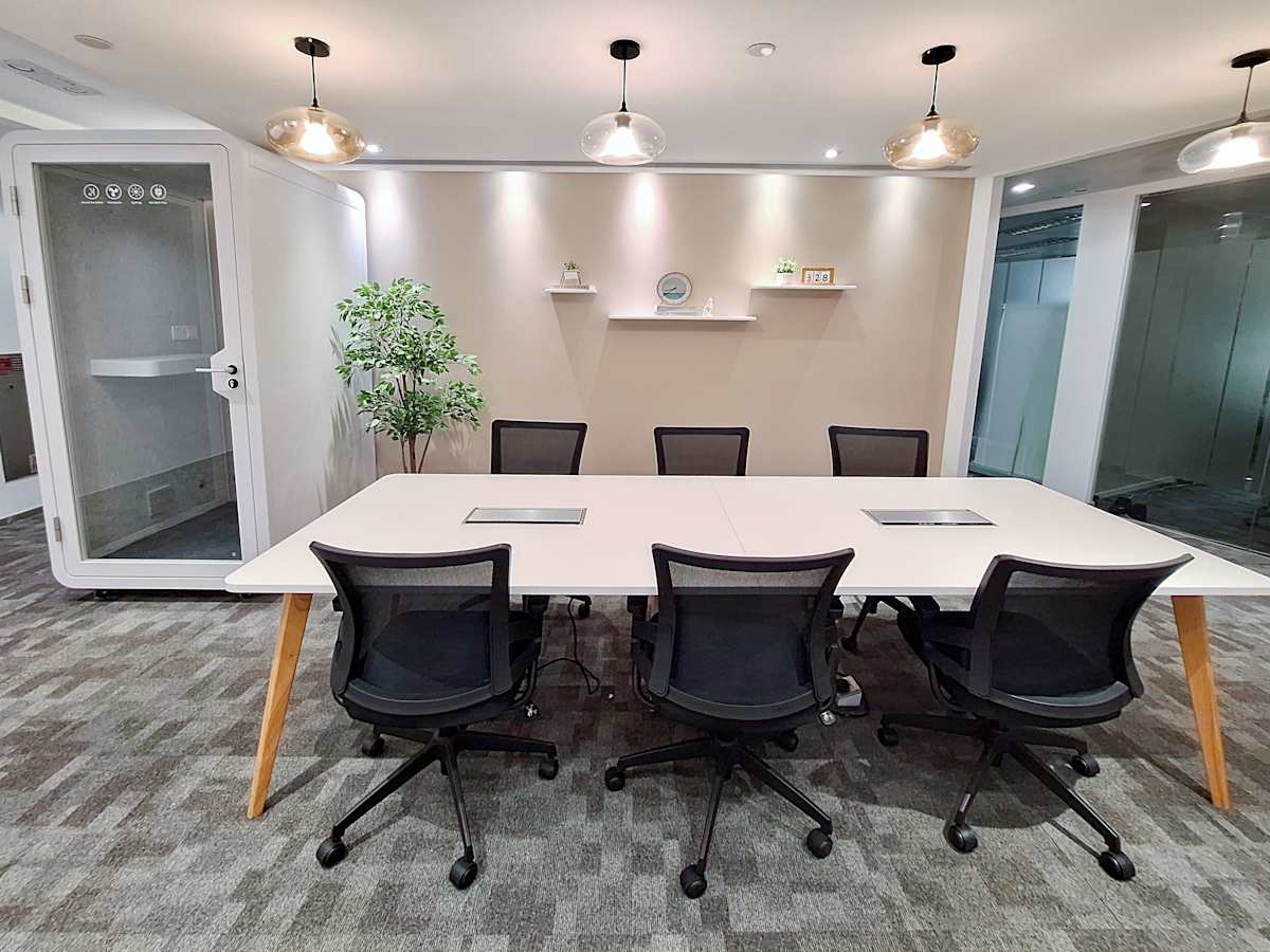Modern meeting room with ample seating, privacy booth, and sleek decor in Queen's Road Central.