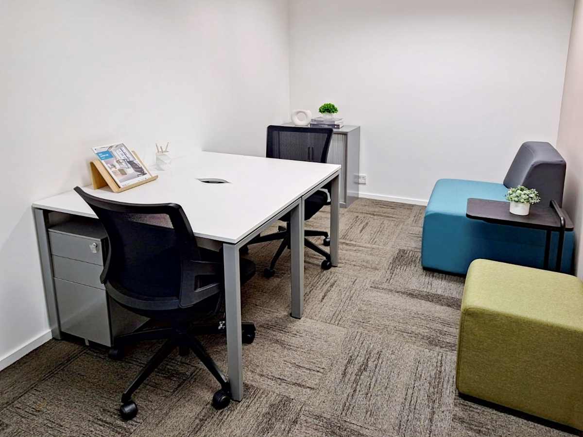 Modern coworking space with minimalist design, ergonomic chairs, and natural light.