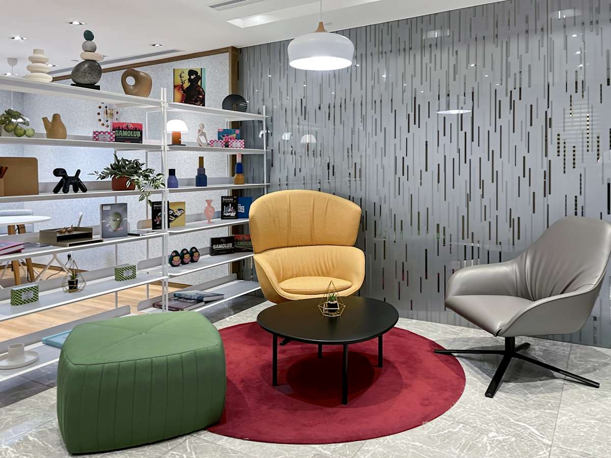Modern coworking lounge with stylish seating, vibrant decor, and a welcoming ambiance.