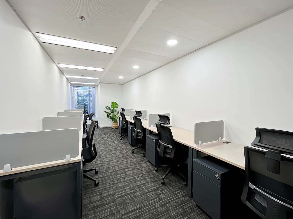 Modern coworking space with sleek workstations and ample natural light on Hysan Avenue.