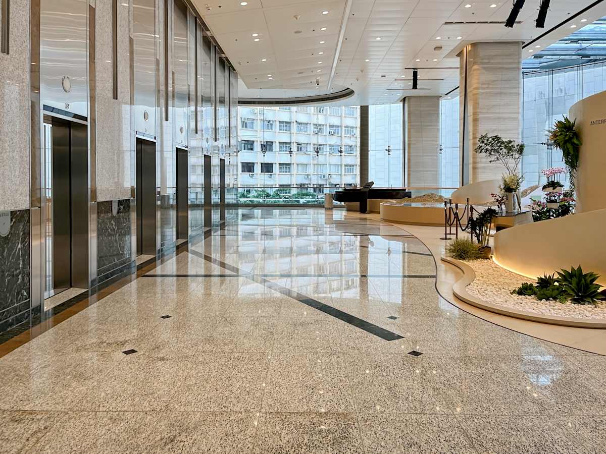 Sleek, modern coworking space with polished floors and abundant natural light on Hysan Avenue.