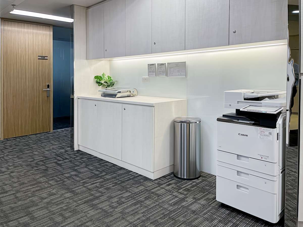 Sleek coworking space with modern cabinetry and essential office equipment for productivity.
