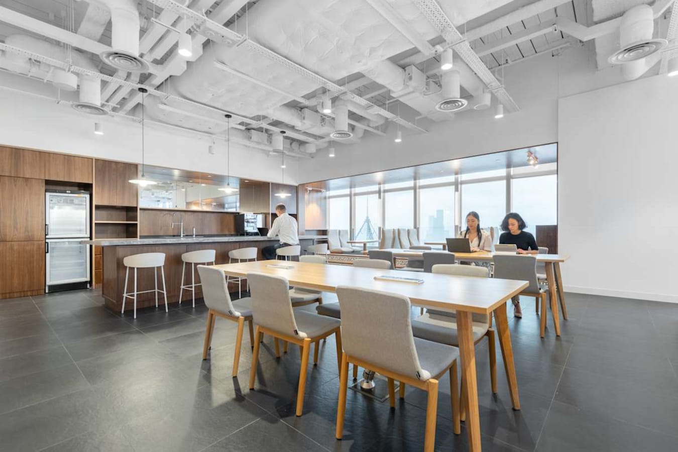 Modern coworking space with natural light, open layout, and sleek kitchen area on Hennessy Road.