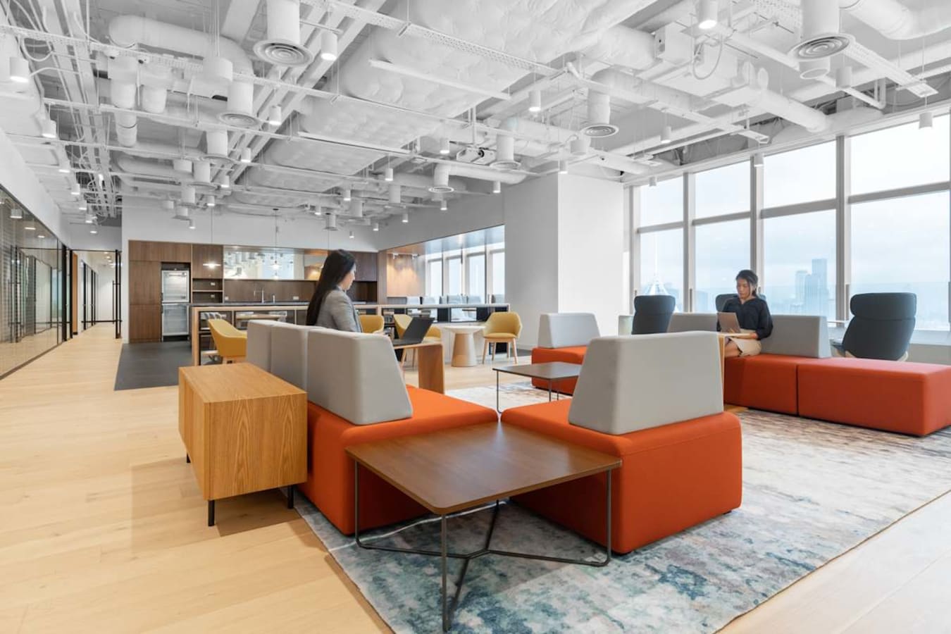 Bright, modern coworking space with open layout, stylish seating, and abundant natural light.