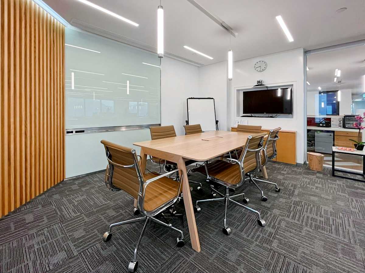 Modern coworking space with sleek wooden accents and ergonomic seating on Queen's Road Central.