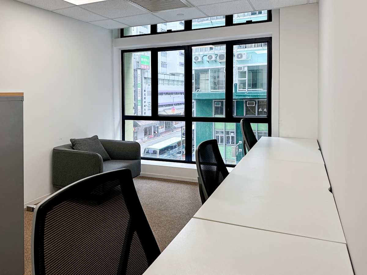 Bright coworking space with large windows and modern furnishings on Hennessy Road.