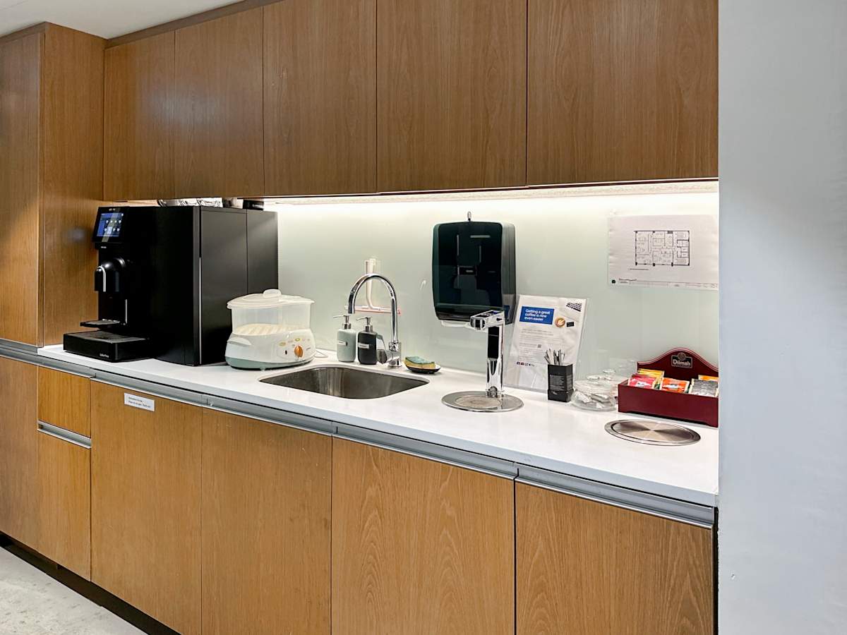 Modern kitchenette with stylish wood cabinets in a flexible coworking space on Hennessy Road.