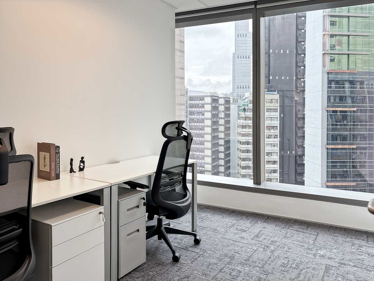 Bright corner office with modern furniture and city views, ideal for productivity and collaboration.