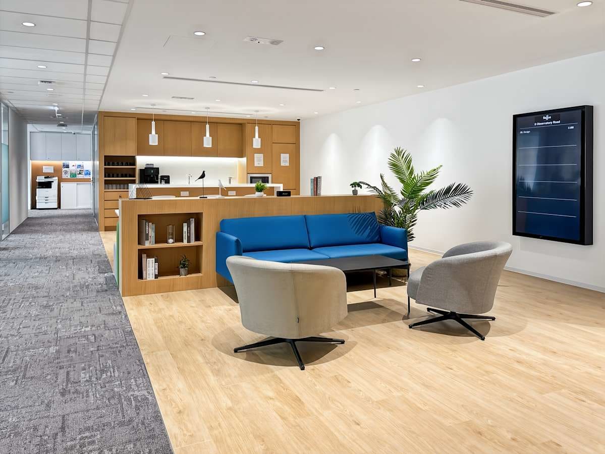 Modern coworking area with sleek seating, ample natural light, and a welcoming atmosphere.