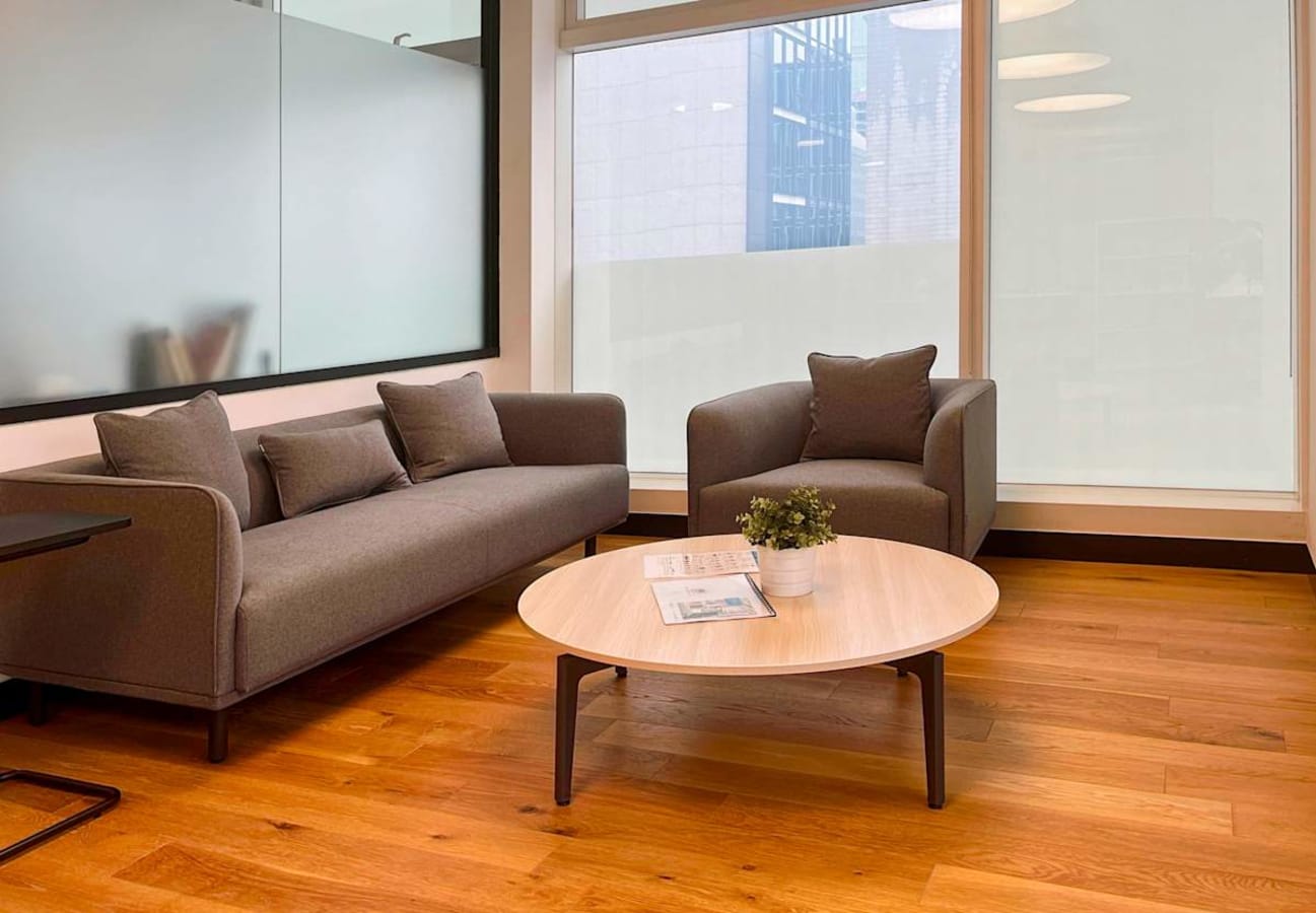Modern coworking lounge with cozy seating and natural light on Wyndham Street.