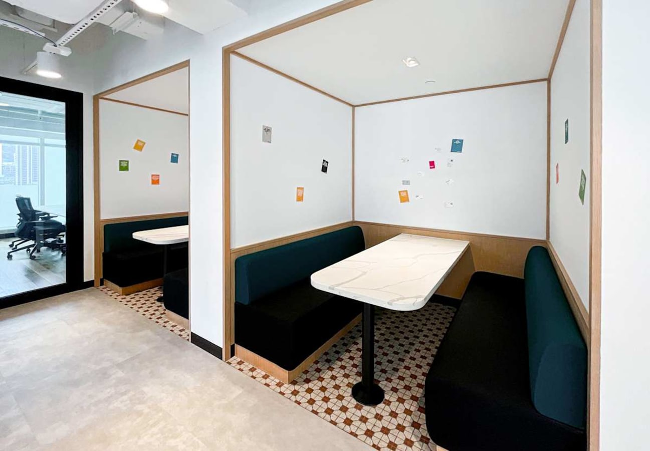 Modern booth seating in a vibrant coworking space, perfect for meetings or focused work.