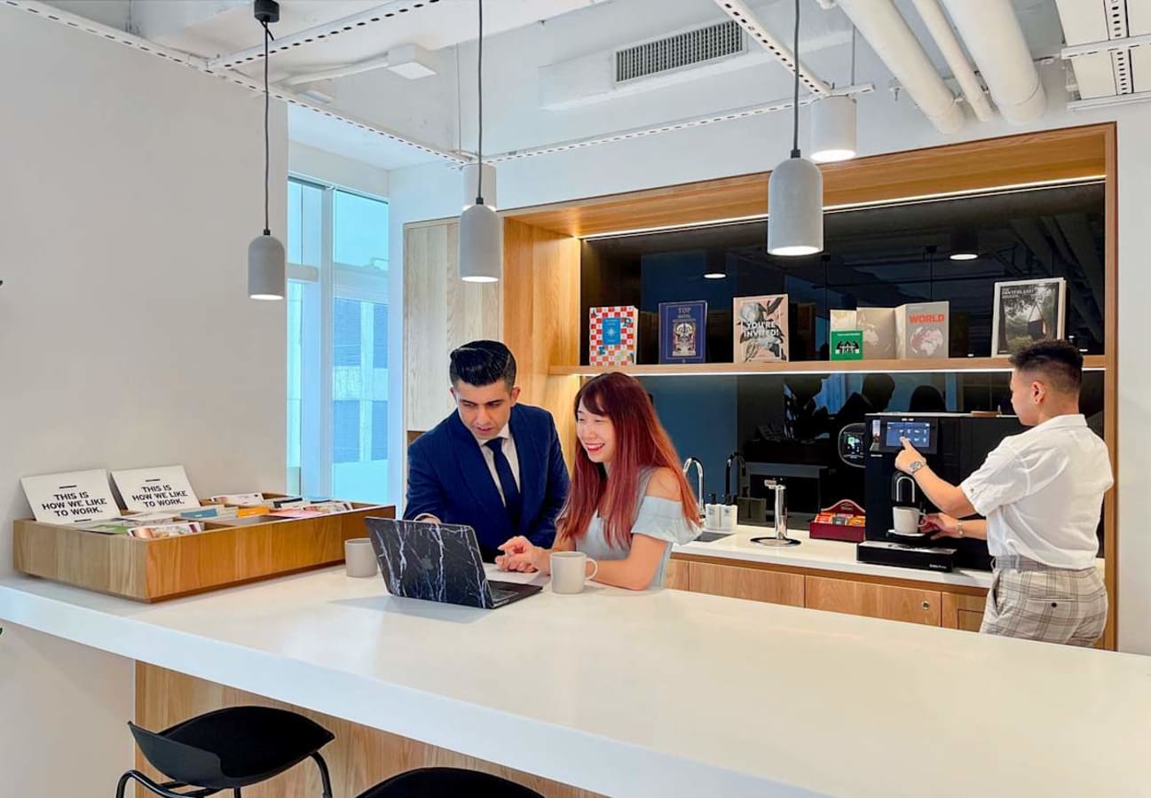 Modern coworking space with open kitchen and sleek seating on Wyndham Street. Perfect for collaboration.