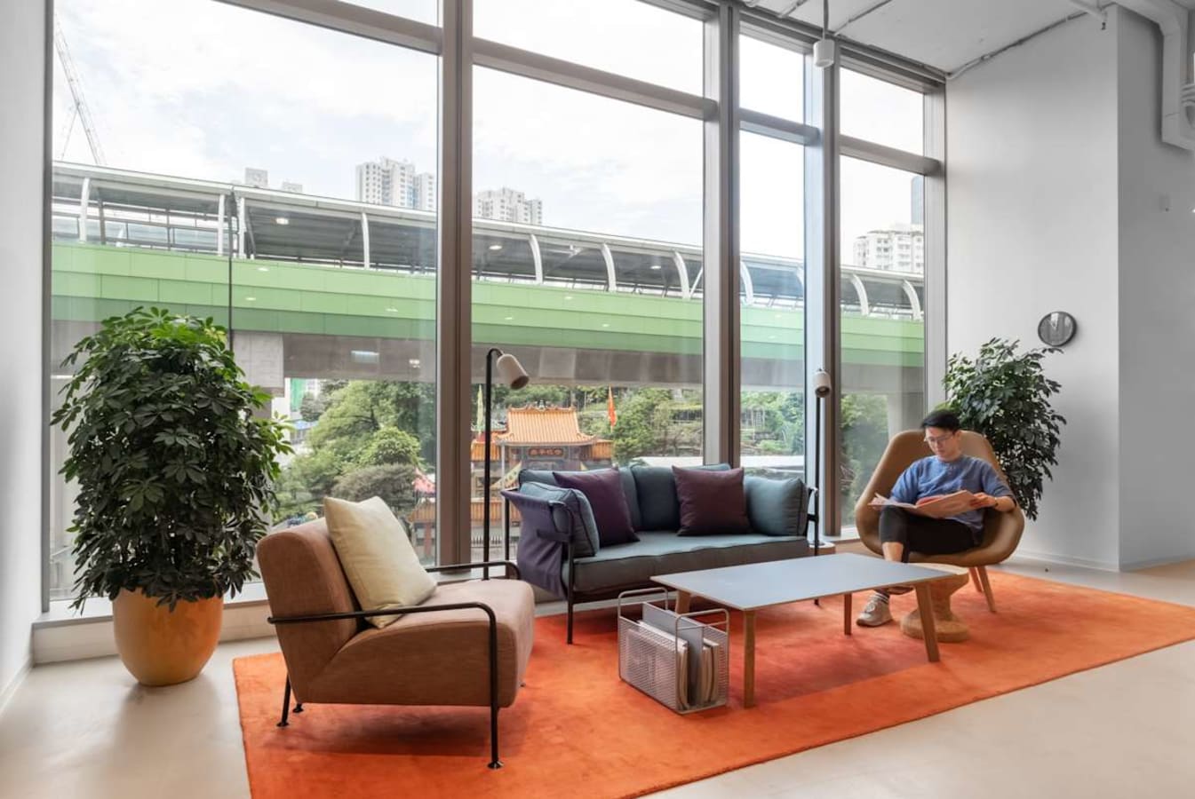 Bright coworking space on Wong Chuk Hang Road with cozy seating and large windows for natural light.