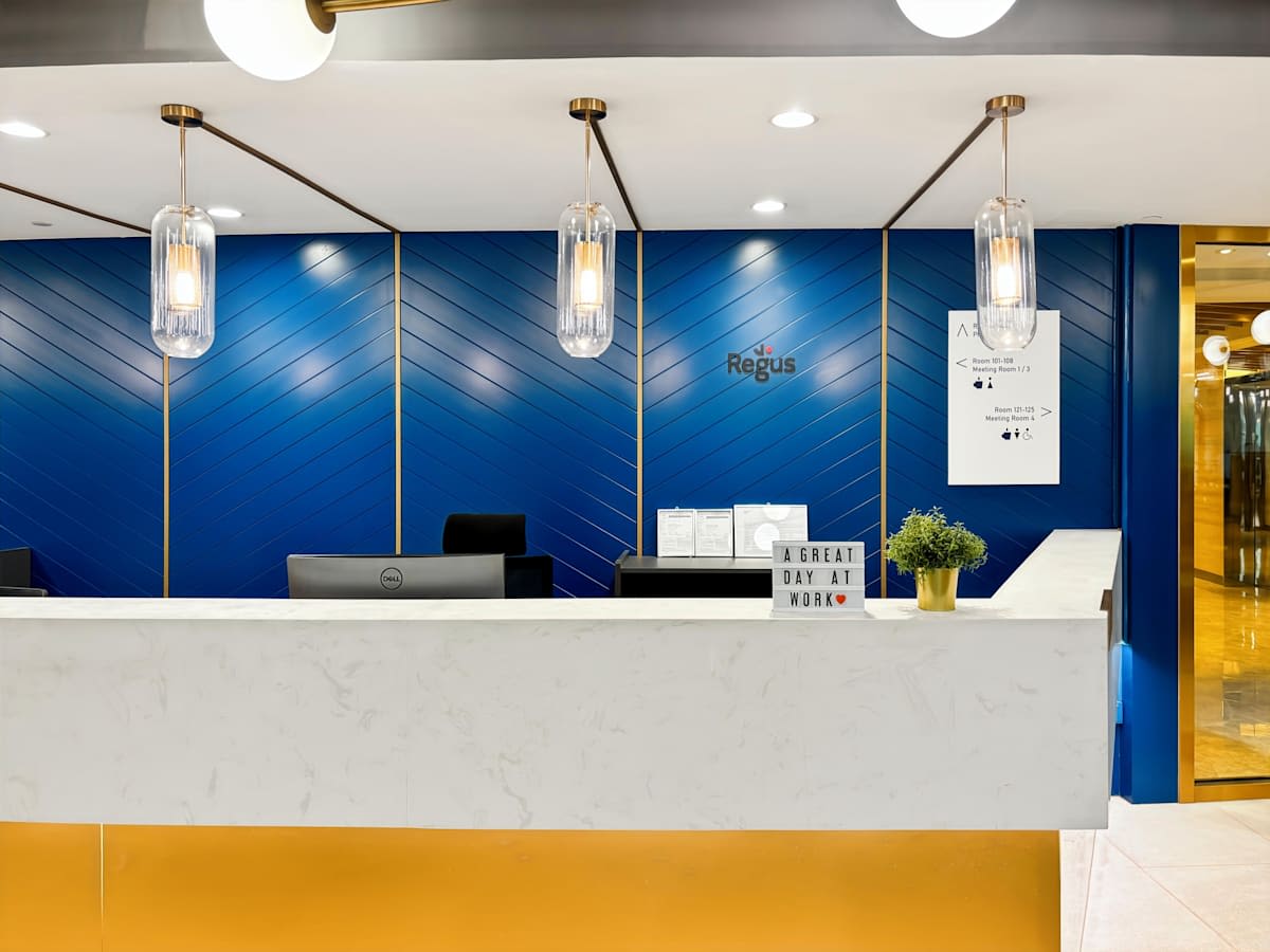 Stylish reception area with modern lighting and sleek design in a Prince Edward Road West coworking space.