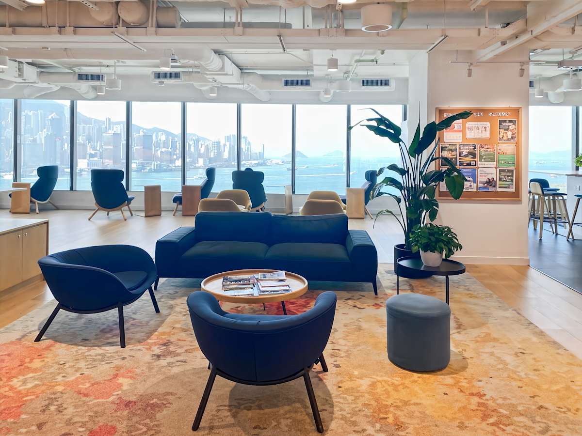 Modern coworking space with skyline views, cozy seating, and bright natural light on Canton Road.